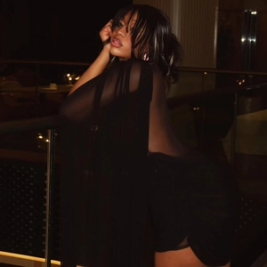 Close-up of ruched black bodycon dress featuring backless design and chiffon texture