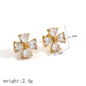 Detail showing 11.8mm gold clover stud earrings with heart-shaped cubic zirconia
