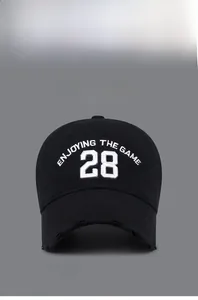 Detailed embroidery of '28' on a black distressed baseball cap with vintage worn brim
