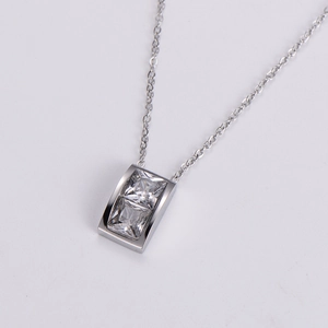Macro shot of silver rectangle pendant with two sparkling square cubic zirconia stones