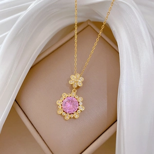 Pink flower pendant necklace in gold with sparkling diamonds on white silk