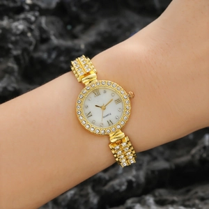 Women's minimalist gold quartz watch with a diamond bezel and white dial on dark rock