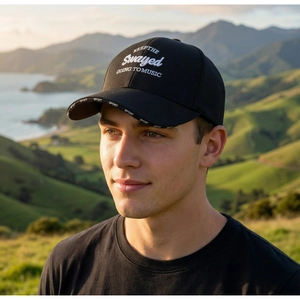 Detail of white 3D embroidery on black twill cotton baseball cap with a long brim