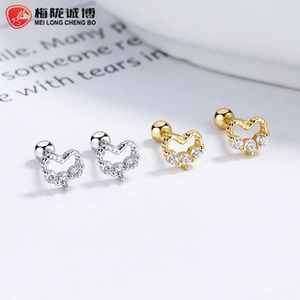 Detailed view of 925 silver heart screw back earrings with zircons in gold and silver