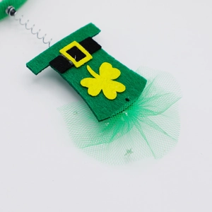 Detail of St. Patrick's Day green mini hat headband with shamrock and green tulle