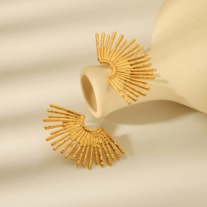 Detailed view of 18K gold plated fan-shaped earrings hanging on an artistic vase
