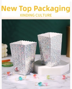 Detail of silver laser popcorn boxes with starry glitter finish and wave edge design