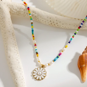 Bohemian style beaded necklace with daisy flower pendant and pearls on white shells