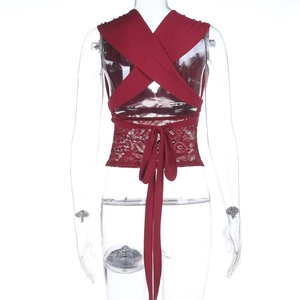 Detail of burgundy lace top featuring back cross-lacing and intricate floral patterns