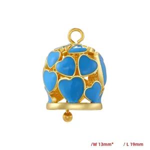 Detailed view of hollow gold bell pendant with blue enamel hearts measuring 13mm by 19mm