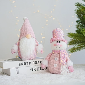 Pink sequined Christmas gnome and snowman plush figurines on a festive holiday backdrop