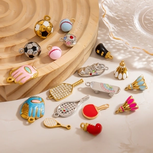 Detailed macro view of assorted stainless steel sports charms with enamel and rhinestones