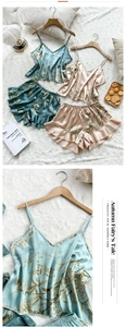 Detail of floral ice silk pajama set featuring V-neck camisole and ruffled hem shorts