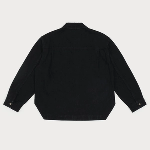Detail view of the back of a black washed denim shirt with premium texture and stitching