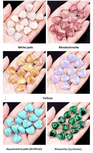 Selection of heart-shaped gemstone pendants with gold and silver metal edges for jewelry