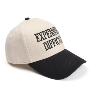 Close-up of letter embroidery on a high-top color-block truck driver baseball cap