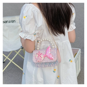 Detail of pink-purple sequin girls purse with mermaid tail and pearl handle