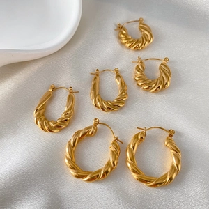 Three pairs of twisted croissant style gold plated stainless steel hoop earrings for women