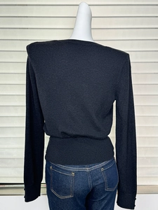 Detail view of the slim-fit wool knit sweater back profile on a mannequin torso