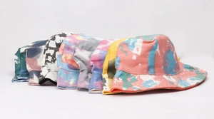 Detailed view of various colorful tie-dye and floral patterns on cotton bucket hats