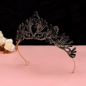 Close-up of Baroque gothic crown with black pear-shaped stones and bronze alloy carvings