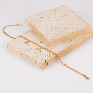 Double-layered stainless steel flower anklet in gold finish on beige stone