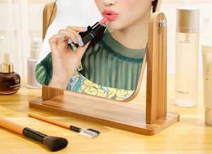 Adjustable wooden tabletop makeup mirror shown in a professional vanity setting