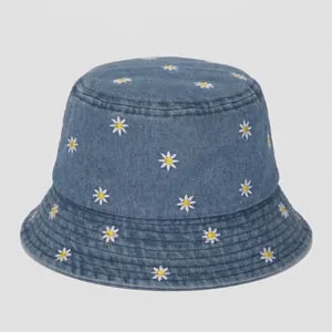 Blue denim bucket hat for women with white daisy floral embroidery and casual sun protection