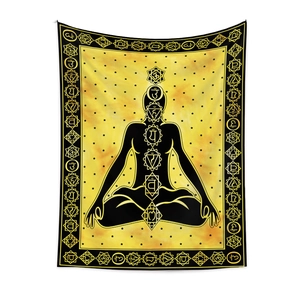 Detailed view of yellow chakra meditation tapestry with chakra symbols and sanskrit design