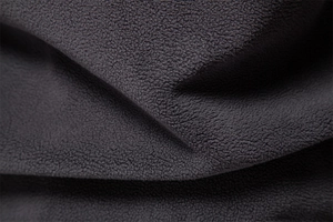 Detail of dark gray high-density fleece fabric showing soft texture and thickness