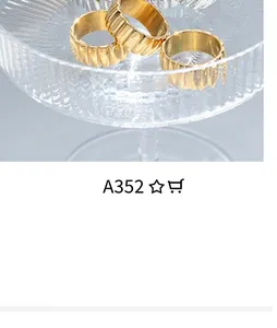 Close-up of golden stackable rings with unique vertical wavy texture and metallic finish
