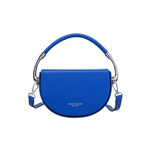 Blue leather saddle shoulder bag with top handle and adjustable strap on white background