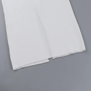Close-up detail showing the white ribbed texture and knit pattern of the dress fabric