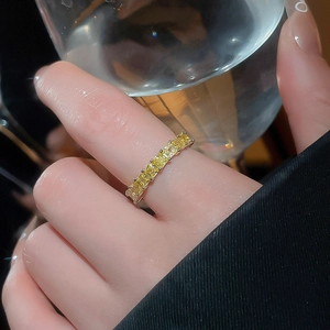 Detailed view of an 18k gold plated ring featuring rectangular yellow zircon stones