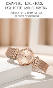 Detail of rose gold ladies watch with mesh strap and minimalist round dial design