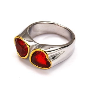 Detail of silver-tone ring featuring two red heart gemstones with golden bezels