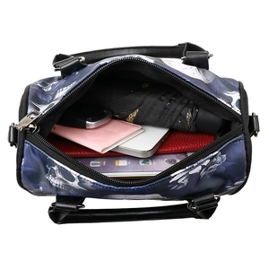 Spacious skull print tote bag showing internal storage for umbrella, wallet and phone