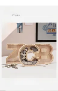 Detail showing letter shaped wooden piggy banks with transparent acrylic front and coins