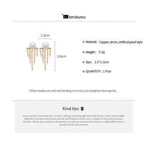 Detailed view of 14K gold plated tassel pearl earrings with zircon marquise stones