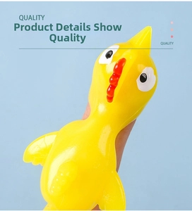 Close-up of yellow TPR finger slingshot chicken toy showing stretchy rubber material