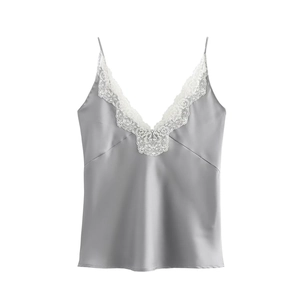 Detailed close-up of grey satin camisole with white lace trim at the deep V-neckline
