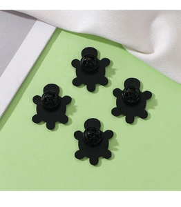 Detail view showing the back of four black turtle brooches with butterfly clasps