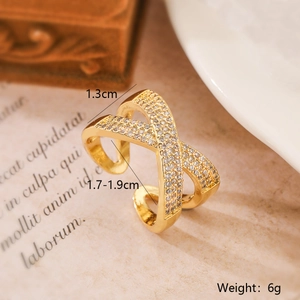 Detailed view of adjustable gold X-shaped ring with sparkling pavé zircons and dimensions