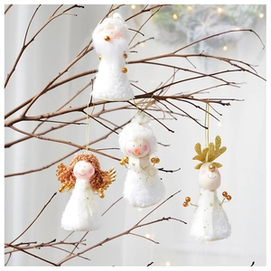 White plush Christmas ornaments with gold wings and sequins on rustic wood branches