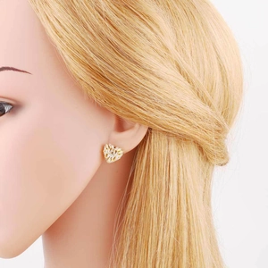 Macro view of gold-plated heart-shaped earrings with micro-pave white cubic zirconia