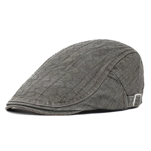 Detail of adjustable metal buckle and quilted fabric on the grey cotton flat cap