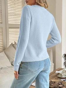 Detail view of light blue knitted sweater showing back texture and slim fit design