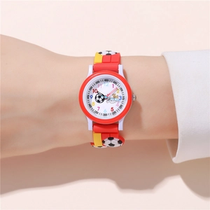 Detail of kids soccer quartz watch with colorful numerals and red silicone band on wrist