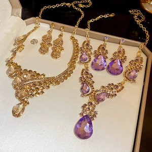Detail of luxury water drop jewelry sets with necklaces and earrings in champagne and purple