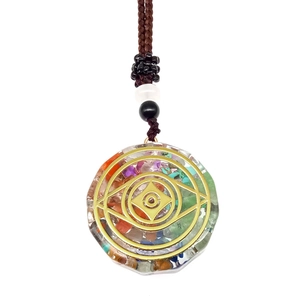 Detailed macro view of energy pendant necklace with colorful crystals and gold pattern